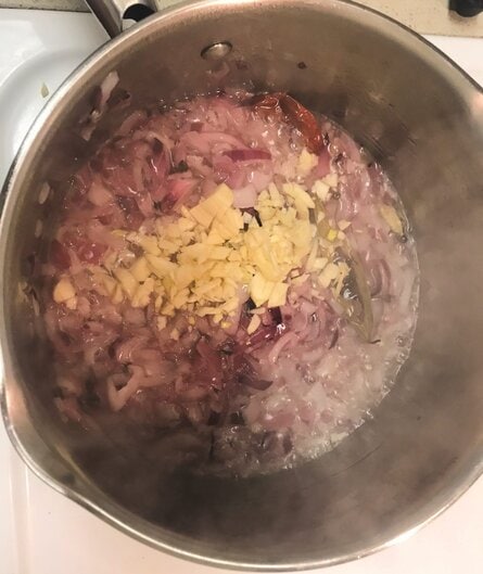 add garlic to pan for chicken curry