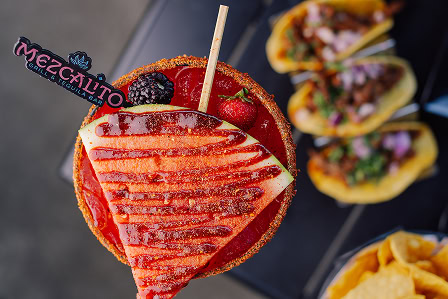 Top view of a large, impressively garnished watermelon margarita from Mezcalito, a modern Mexican restaurant in Midtown Raleigh