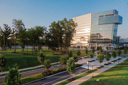 Exterior view of a mirrored office tower at 1000 social, offering luxury offices and commercial space available for lease in Raleigh at The Exchange