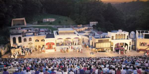 A lively outdoor theater performance with an audience in Eureka Springs, Arkansas.