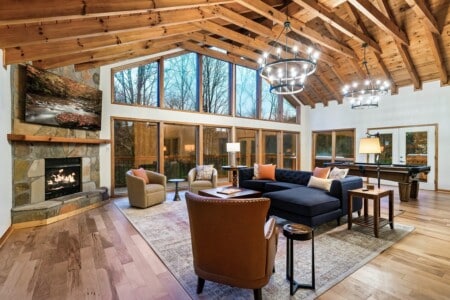 Cozy living room with vaulted ceilings, a fireplace, and a large smart TV. Perfect for relaxing together.