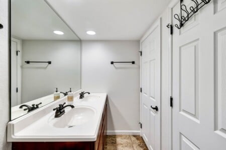Lower-level bathroom with a dual vanity for extra convenience.