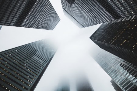 High-rise skyscrapers viewed from below in a cityscape, emphasizing corporate growth and urban devel.