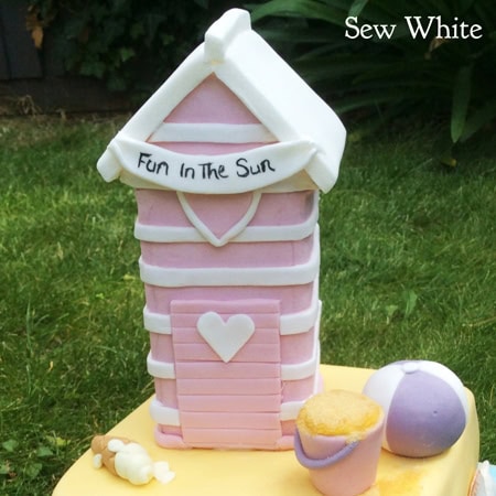 beach hut cake in pastel pink and white