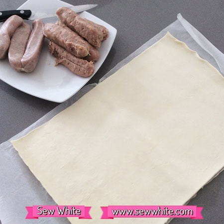 how to make mustard sausage rolls pastry and sausages on a kitchen table