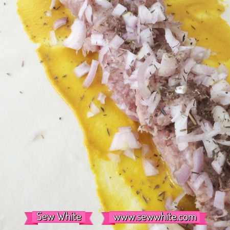 pastry sheet with mustard, sausge meat and red onion