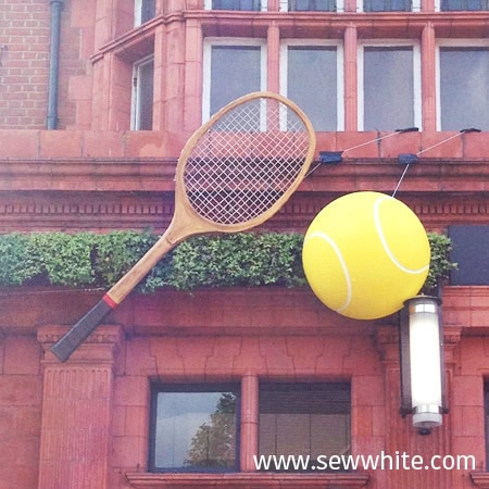 All bar one in Wimbledon ready for the tennis in 2015 with giant ball and racket hung up outside