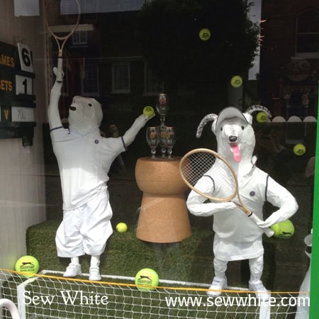 Dogs playing tennis in a shop window