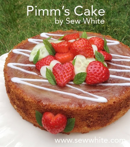 Pimm's Cake topped with strawberries and cucumeber hearts and sprigs of mint