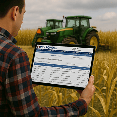 Image of a farmer in a field holding a tablet with eWorkOrders CMMS. Looking at a work order to fix his tractors.