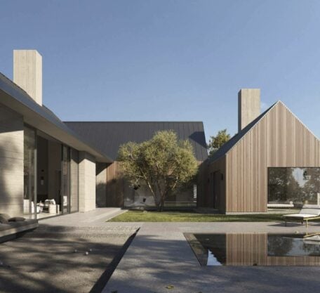 Modern residential house with wood and concrete exterior, outdoor seating, and reflecting pool.