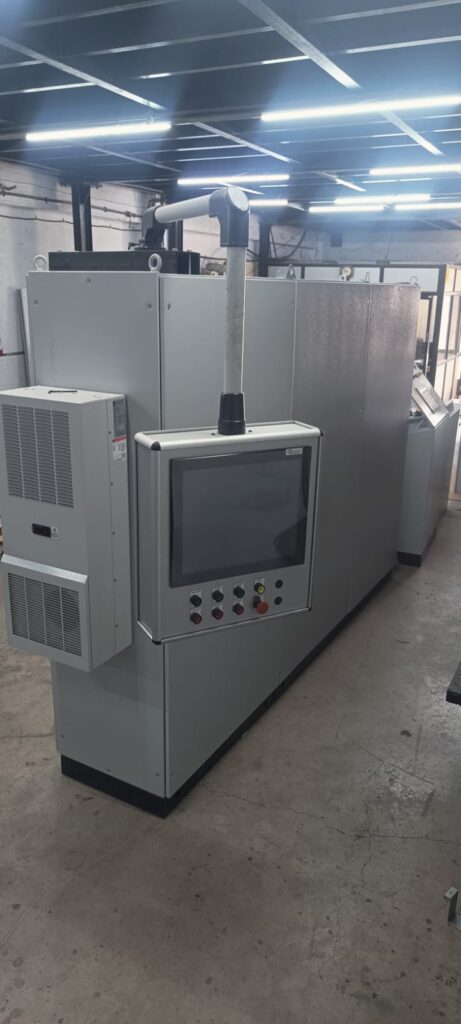 industrial HMI cabinet mounted on support arm with wiring and control system