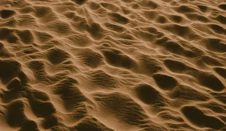 Feeling Stuck | Trauma Therapy for Feeling Trapped | Trauma Therapy | Anxiety Help | Farmington Hills, MI | Detroit, MI | Ann Arbor, MI A person sinking into quicksand with arms struggling upward, symbolizing feeling stuck and overwhelmed, often explored in trauma therapy for anxiety in Farmington Hills, MI.
