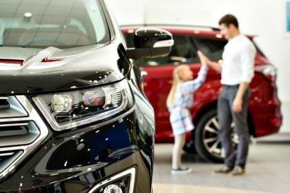 Dad and daughter buying a car.