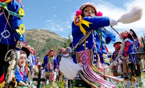 Traditional dancers performing at the Paucartambo festival during a Cusco highlights tour.