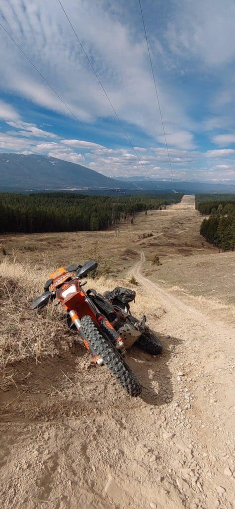 motorcycle leaning on it's side on hill