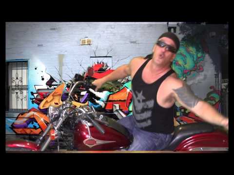 sitting on a motorcycle in front of a colorful graffiti wall