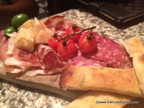 Antipasto carne: Salame Piacentino, coppa, Parma ham, vine ripened roasted cherry tomatoes, Parmigiano Reggiano, (matured for 18 months), fresh green olives & Sardinian flat bread 20-Pontis Italian Oxford Circus (20)