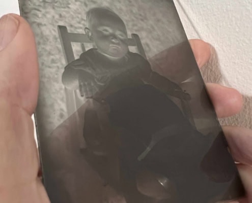 Hand holding a glass negative. C.1930's
