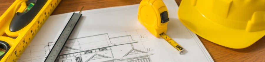 Building contractor reviewing construction plans for Cape Town property renovation
