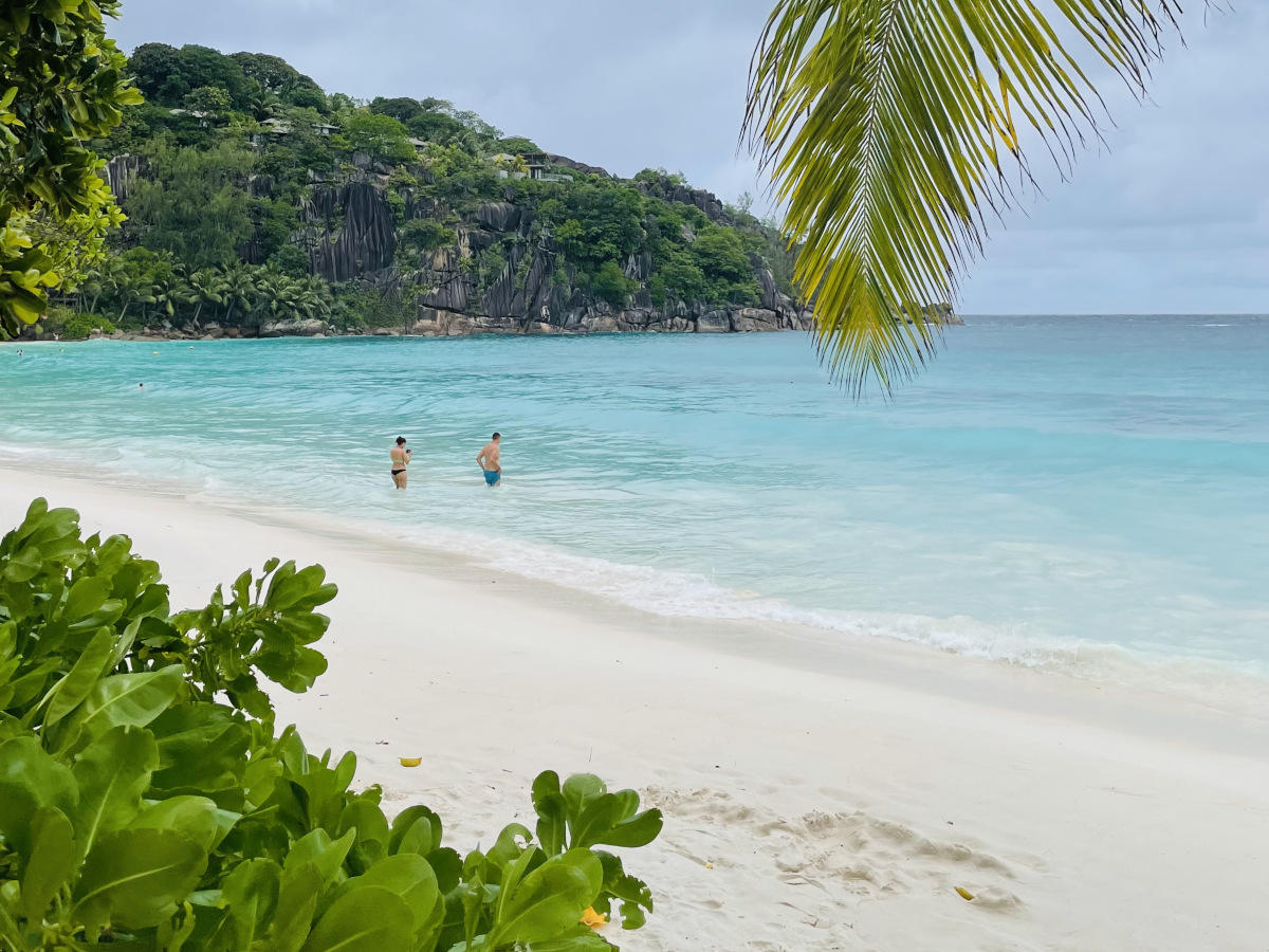 petite_anse_beach_mahe View of tropical beach in Mahe with two people in the water
