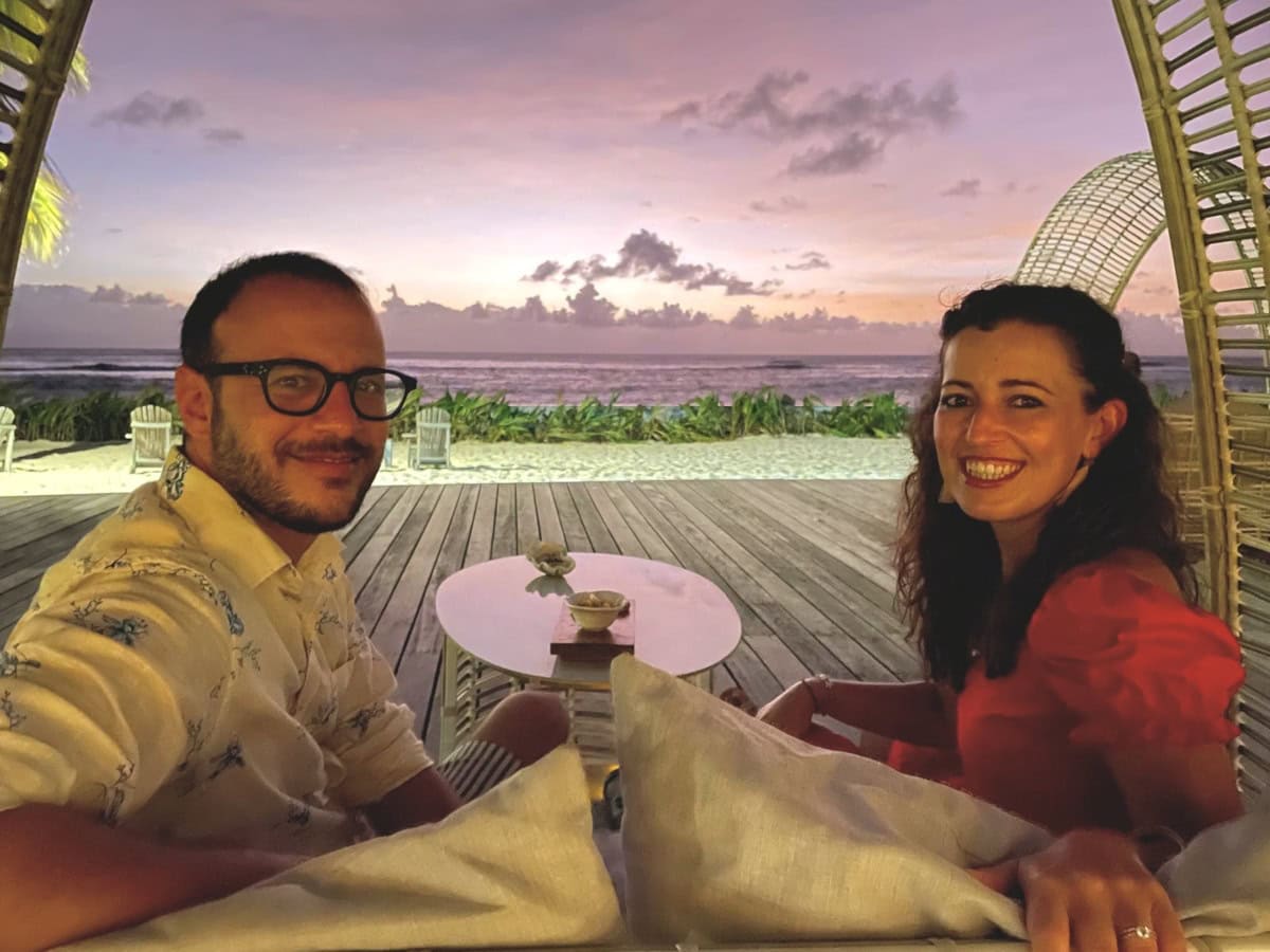 sunset_denis_patio Couple watching sunset by a wooden deck at the beach
