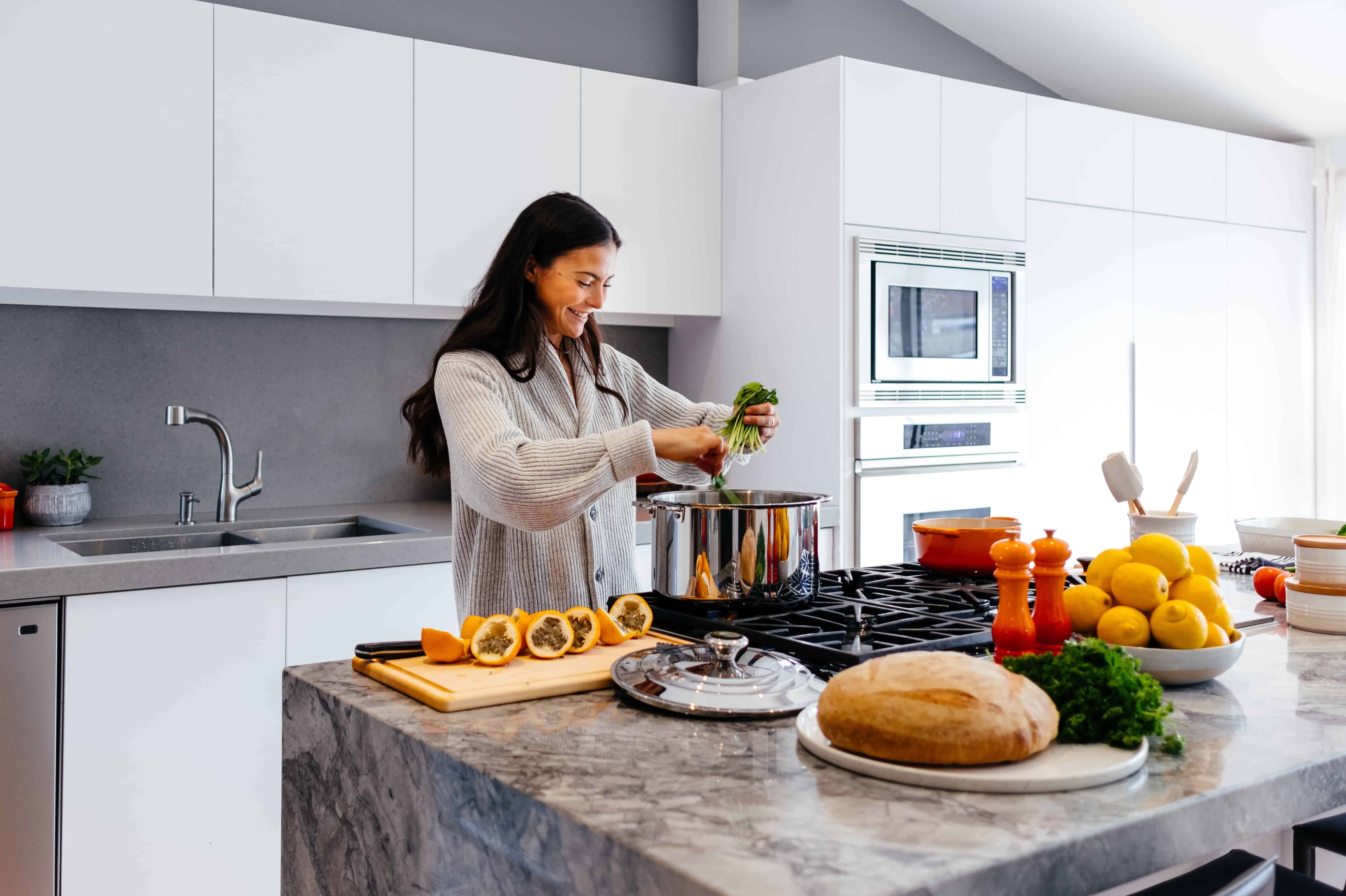 Woman in kitchen cooking with a mindset for health