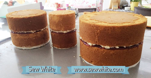 Three tiers of cake ready to be stacked