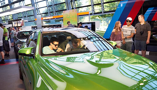 Students inside a car at the Munich BMW factory