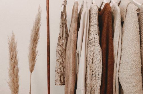 winter capsule wardrobe sweaters hanging on a rack