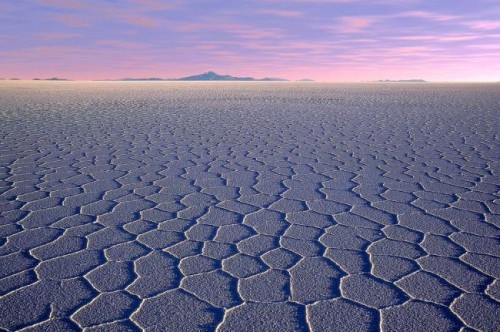 The white crust of the Uyuni salt flats stretch off to the horizon