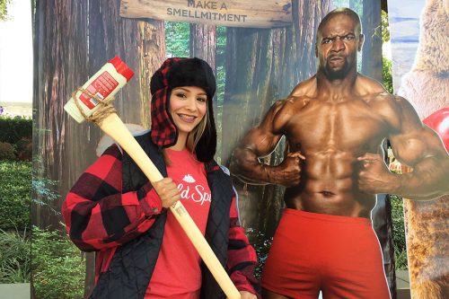 old spice campus event - girl holding deodorant axe next to cardboard cutout