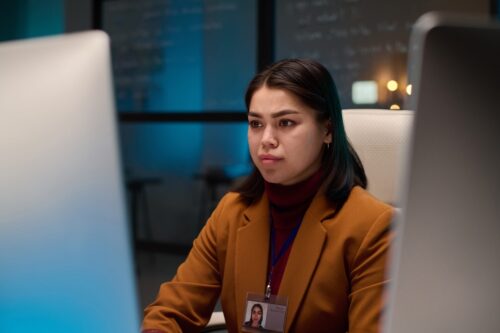 Woman looking at a computer screen in a business office