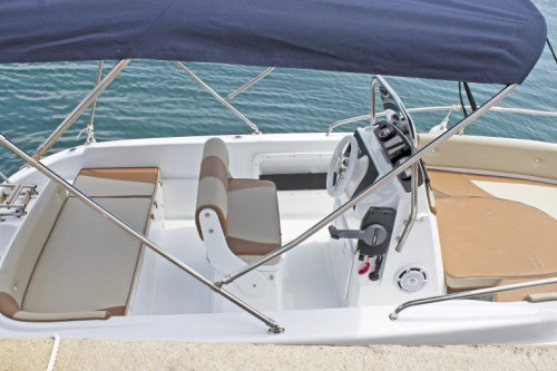 Side view of Syros 190 interior showing steering console, seating, and open layout