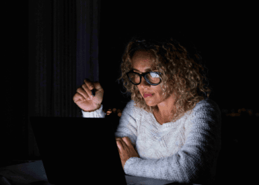 Schmidt concerned woman working a laptop at night