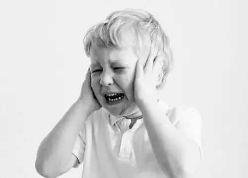 Crying toddler covering ears, separation anxiety tantrum