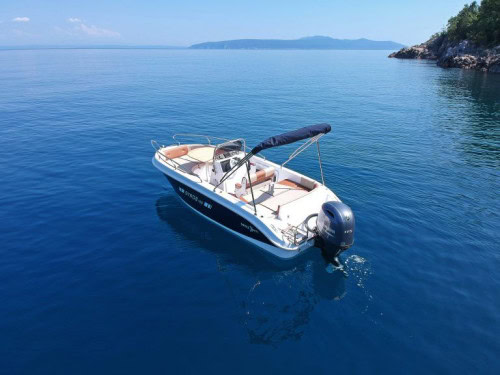 Bird’s-eye rear-side view of Syros 190 showing seating, sunbathing deck, and outboard engine