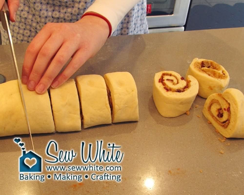 Cutting up the rolled Cranberry and cinnamon buns