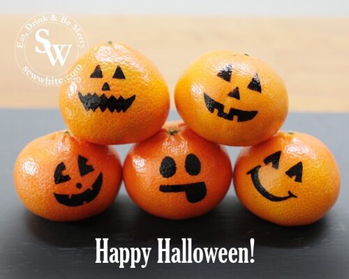 Cute little oranges with pumpkin faces drawn on Healthy Halloween Snacks