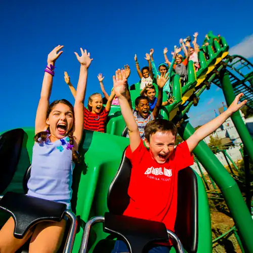 Thrilling roller coaster ride at 407 Vacations amusement park with excited children.