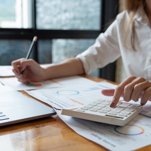 Candid picture of a business team collaborating. Filtered with light flares and cool tones.