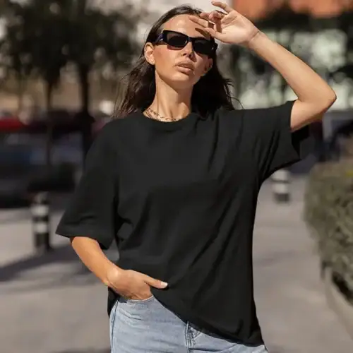 Black premium oversized custom tee lifestyle front view, oversized fit with dropped shoulders and clean print surface