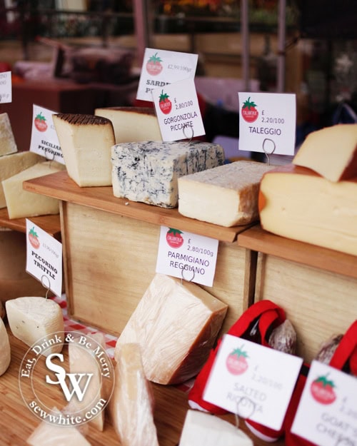 cheese stall with lots of cheese types