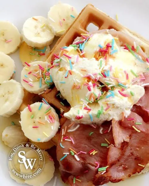 The Best Brunch Waffles topped with bananas, bacon, ice cream and sprinkles