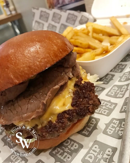 Close up of the roast beef burger with cheesey chips at dip and flip