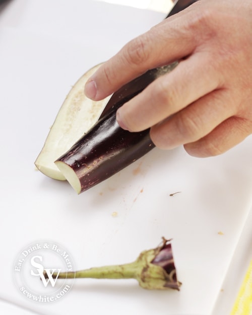 vibrant and little baby aubergines being sliced for the cookery day.