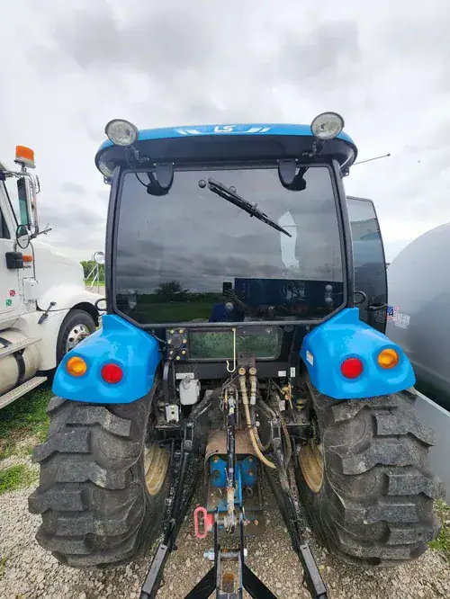 Rear view of a blue agricultural tractor with custom window tinting installed by Valion Tinting, demonstrating our ability to handle specialty and heavy equipment glass in Kansas City
