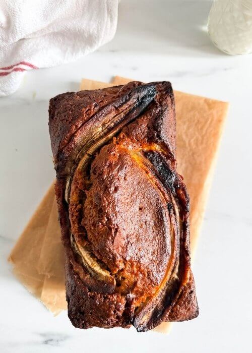 Super Easy 4 Ingredient Banana Bread - Delicious Dessert Recipe 1 from top 4 ingredient banana bread, on marble background, a glass of milk and towel on the side