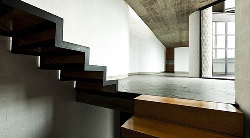 Contemporary residential staircase with modern wood finish and minimalist design.