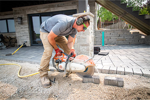landmark landscapes employee sawing